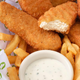 Beyond Meat Chicken Tenders in a basket with fries and dipping sauce